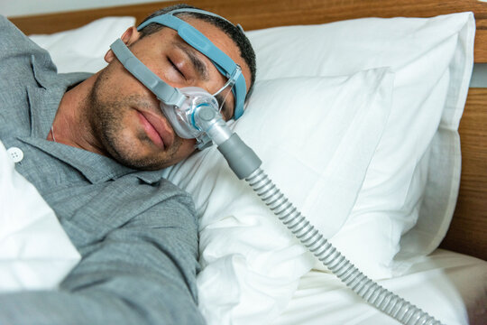 Man sleeping with CPAP machine