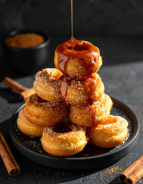 Bunuelos with piloncillo syrup on volcanic stone
