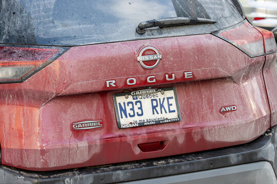 Canada, Montreal, 24 December 2025 : Red Nissan Rogue with Quebec license plate in winter grime