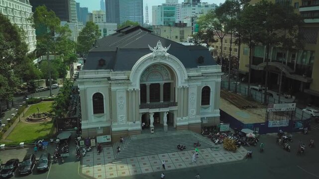 Aerial perspective of the historic saigon opera house surrounded by bustling city traffic in vietnam