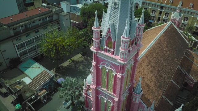 Aerial shot slowly orbiting the pink tan dinh church, a historic landmark in ho chi minh city