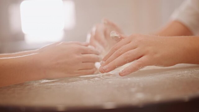 Closeup caucasian hands kneading dough on countertop, intimate home baker scene with soft sunlight and flour dust, gentle motion forming pumpkin pie base, warm cozy autumn atmosphere, tactile textures