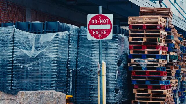 Do Not Enter next to stack of pallets 