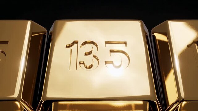 Glinting center gold bar stamped 135 catching moving studio light at dark backdrop showing 135 mark