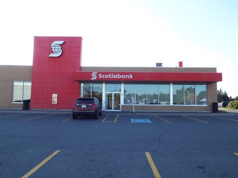 Gloucester, Ontario, Canada &ndash; July 24, 2026: The "Scotiabank" storefront features a prominent red facade, glass entrance, and a dark SUV parked in an asphalt lot at 655 Earl Armstrong Rd.
