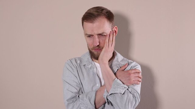 Portrait of resentful man on beige background