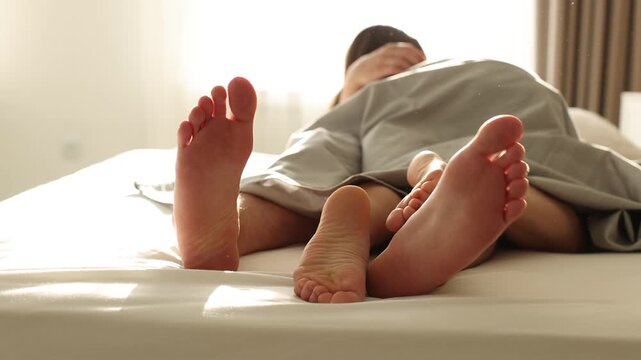 Lovely couple having sex in bed at home, closeup. Camera moving forward