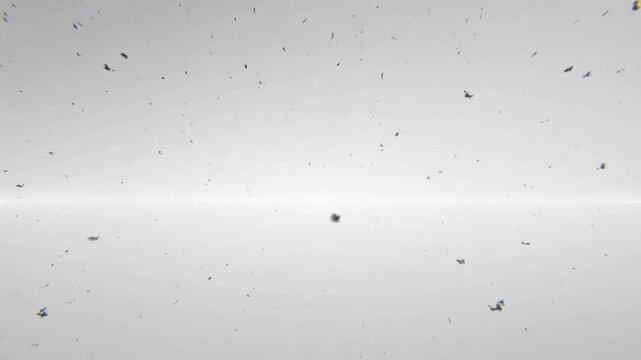 Starting playback sending dust and chunks drifting outward, dispersing across gray banded backdrop