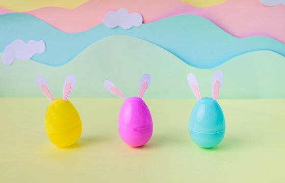 Pastel Easter eggs with bunny ears arranged in studio for spring holiday Happy Easter concept.