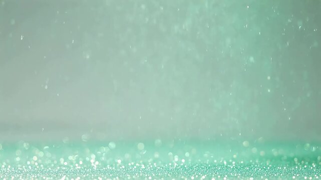 Abstract sparkling glitter texture with radiant bokeh lights in a soft mint green hue, perfect for backgrounds