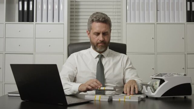 Businessman at office desk with money counting machine. Finance expert. Banker money counting in office. Banking process with cash. Business success with cash counting.