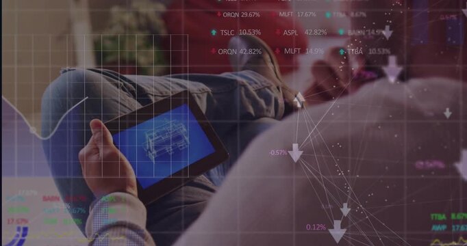 Vertical video: Man on couch tapping tablet, analyzing schematic while tech data overlay growing