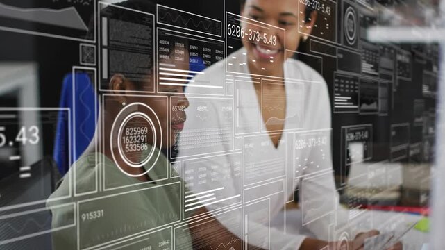 Lead leaning, pointing at monitor, urging analyst typing to review data while HUD charts overlaying