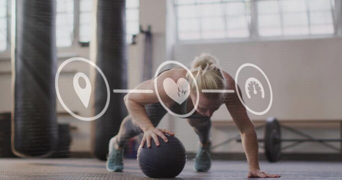 Woman starting on medball shifting weight rotating doing pushup for balance fitness icons over her