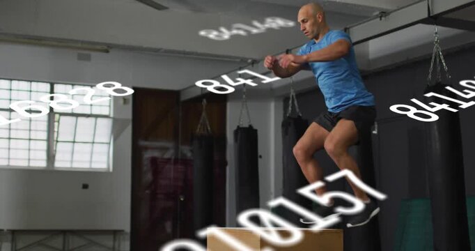 Man shifting weight back pushing off landing jumping onto plyo box for fitness numbers tracking him