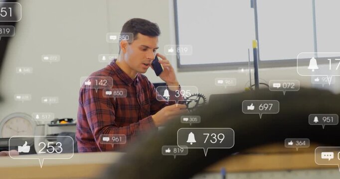 Technician answering call and inspecting bicycle gear for repair at bench, alerts rising around him