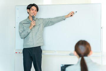 Male engineers, instructors, and technicians in work clothes conducting training sessions, seminars, study groups, and presentations in factories and conference rooms. © buritora