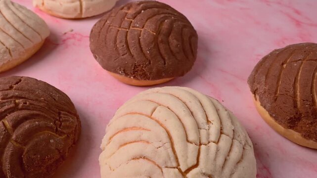 Assorted sweet bread buns with seashell-shaped sugar topping, Mexican conchas