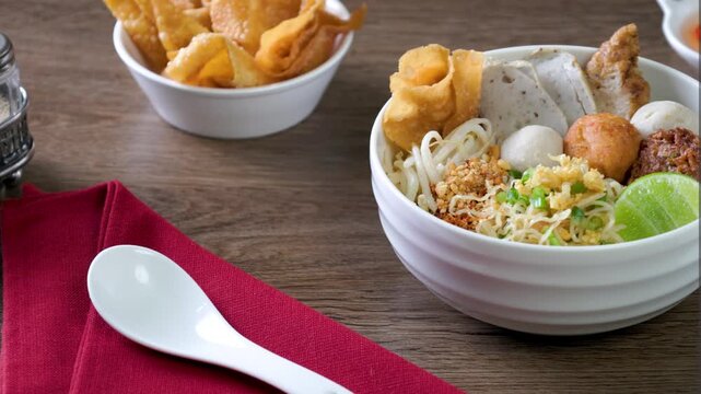 dry Chinese yellow noodles with bean sprout topping pork meatball 