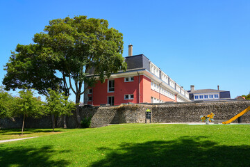 Fototapeta premium The Public Finance Center building overlooking the medieval ramparts and playground in Boulogne-sur-Mer, France