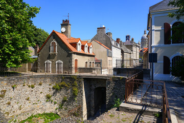Fototapeta premium Perspective of the Porte des Degrés walkway and historic houses with the Basilica dome in Boulogne-sur-Mer, France