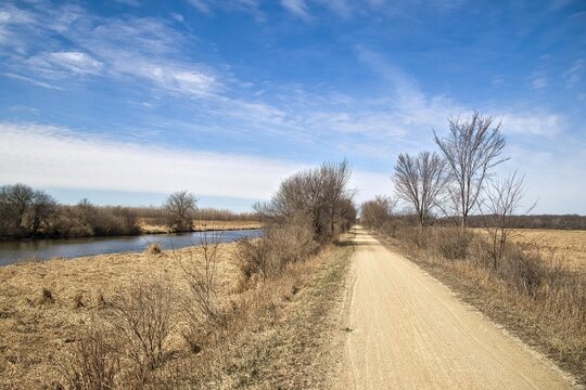 Beautiful landscaping featuring the Glacial Drumlin State Trail passing beside a small stream in the marsh and forest near Dousman, Wisconsin.