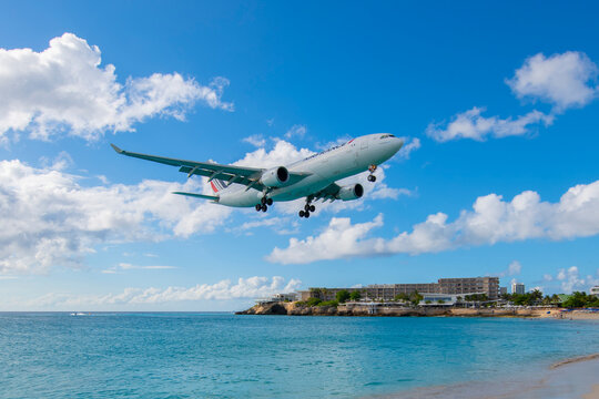 Air France Airbus 330-200 F-GZCC flying over Maho Beach before landing on Princess Juliana International Airport SXM on Sint Maarten, Dutch Caribbean. 