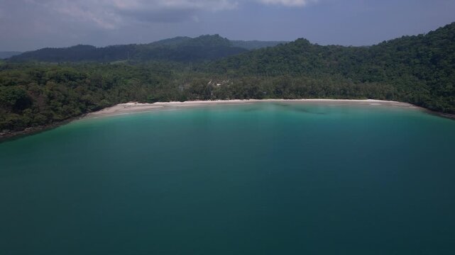 Blue Bay With White Sand Beach Between Green Hills On Koh Kood Island, Trat, Thailand. wide aerial shot