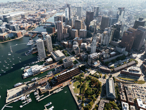 Aerial view of Boston Harbor marina with sailboats, waterfront skyline and cityscape on a sunny day. g.
