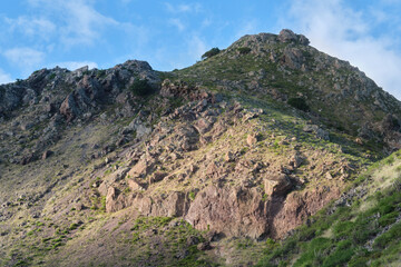 Fototapeta premium Rocky mountain landscape with blue sky and rugged hillside