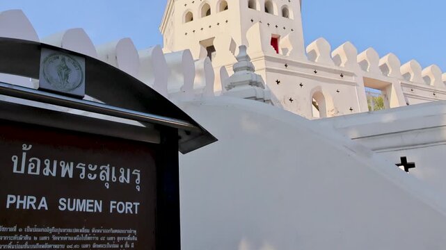 Visitor approach sign at ancient urban landmark in evening light