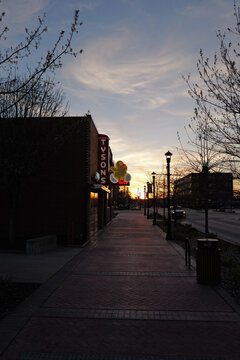 up and coming trendy Emma Avenue and the nostalgic Tyson's Chicken neon sign in Springdale, Arkansas during a warm sunset