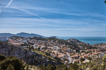 Fototapeta premium Panoramic waterfront view of Marseille with harbor, hills and dense urban fabric