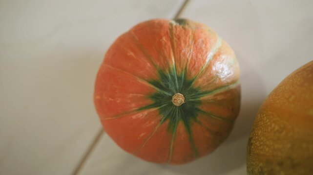 Modern kitchen setting featuring fresh pumpkin with unique stem design. Detailed view of vibrant green pumpkin with starshaped stem under bright daylight in contemporary kitchen setting