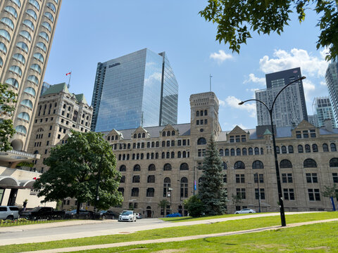 Historic stone building and modern Deloitte tower in downtown - Montreal, Canada - July 2, 2025