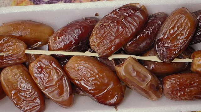 Enjoying fresh dates at a local market in the afternoon