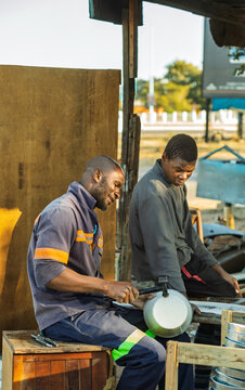 African Tinsmith Entrepreneurs Scaling Small Business Production local metalwork manufacturing.