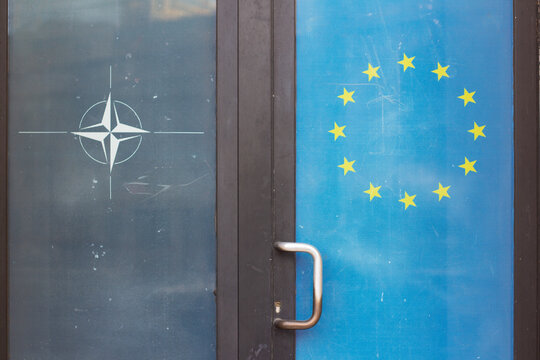 Tbilisi, Georgia - January 14, 2026: Sticker on house door with logo of Information Center of North Atlantic Treaty Organization NATO, compass, wind rose, flag of European Union, EU with stars on blue