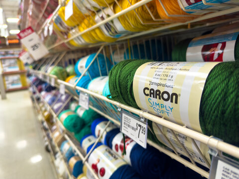 Calgary, Alberta, Canada. March 30, 2026. Shelves of colorful Caron Simply Soft yarn displayed in the craft aisle of a retail store.