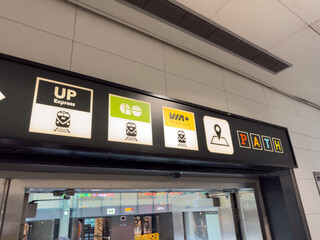 Fototapeta premium Transit sign with UP Express, GO, VIA Rail, and PATH logos inside a transit station - Toronto, Canada - June 24, 2025