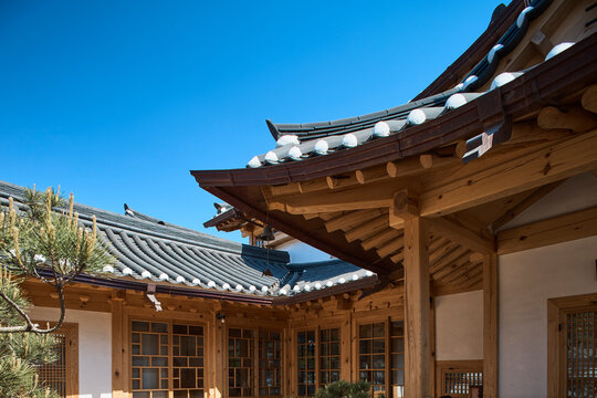 Close view of Korean hanok eaves and timber structure in bright daylight