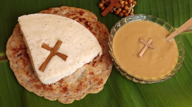 Easter Pesaha Appam, Bread ,Paal religious Christian food on Maundy Thursday, Happy, Good Friday with rice flour Kerala India. Palm Sunday. Top view cross of coconut palm leaf background.