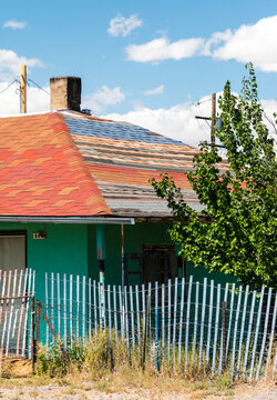 USA, CO, Antonito. House with multi colored roof shingles.