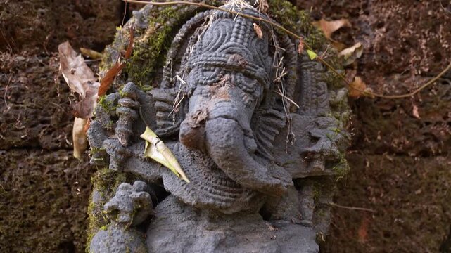 Ancient Ganesh idol in jungle, Karwar, Karnat.aka. Lord Ganesha statue in ruins surrounded by forest