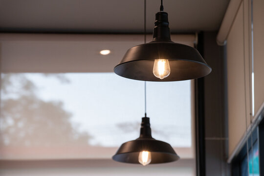 Two industrial-style pendant lamps illuminate dim space