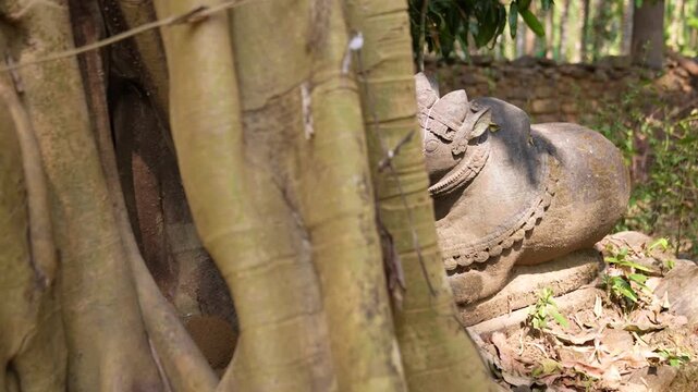 Close up of Nandi idol carved from stone.Stone sculpture of Nandi bull in temple ruins.