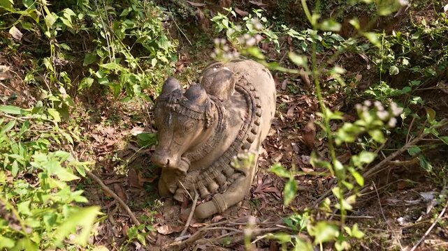 Close up of Nandi idol carved from stone.Stone sculpture of Nandi bull in temple ruins.