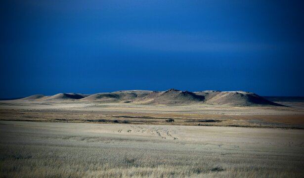 Dark blue skies cloak rugged Montana hills