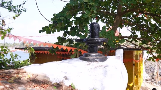 Big Shivling near beach in Karwar Karnataka.Shiva lingam surrounded by trees near coastline India.