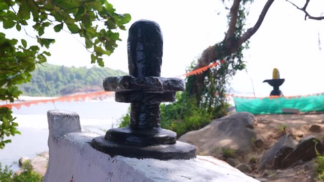 Big Shivling near beach in Karwar Karnataka.Shiva lingam surrounded by trees near coastline India.